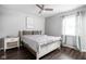 Serene bedroom featuring a soft bed, neutral decor, natural light, and wood-look floors at 6429 Walnut Way, Brownsburg, IN 46112