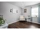 Cozy sitting room with natural light, elegant chandelier, chair, and stylish decor on wood-look flooring at 6429 Walnut Way, Brownsburg, IN 46112