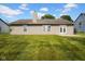 A home exterior showcasing a spacious, well-maintained lawn with a chimney and neutral siding at 652 White Ash Trl, Mooresville, IN 46158