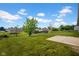 Expansive backyard with lush green grass, mature trees, and a concrete patio, perfect for outdoor activities at 652 White Ash Trl, Mooresville, IN 46158
