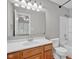 Well-lit bathroom with a shower-tub combo and a wooden vanity with a white sink at 652 White Ash Trl, Mooresville, IN 46158