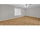 A bright bedroom featuring hardwood floors, a ceiling fan, and neutral paint at 652 White Ash Trl, Mooresville, IN 46158