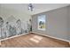 Bright bedroom with hardwood floors, a window with natural light and a decorative forest mural at 652 White Ash Trl, Mooresville, IN 46158