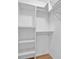 Bright walk-in closet with white shelving and hardwood floors for a functional storage space at 652 White Ash Trl, Mooresville, IN 46158