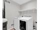 Well-lit laundry room with modern washing machine, a dryer and convenient overhead shelving at 652 White Ash Trl, Mooresville, IN 46158