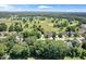 A panoramic aerial view showcasing a golf course community with mature trees and well-manicured lawns and landscaping at 7250 Royal Oakland Dr, Indianapolis, IN 46236
