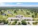 Extensive golf course aerial displaying ponds, trees, parking, and clubhouse for resort-style living and convenience at 7250 Royal Oakland Dr, Indianapolis, IN 46236