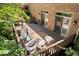 Backyard deck featuring a swing, table, rug, and lots of nature all around at 7250 Royal Oakland Dr, Indianapolis, IN 46236