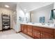 Large bathroom featuring dual sinks, a vanity, large mirror, and separate shower and tub at 7250 Royal Oakland Dr, Indianapolis, IN 46236