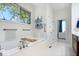 Serene bathroom with a soaking tub, a large window, and a towel rack at 7250 Royal Oakland Dr, Indianapolis, IN 46236