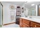 Well decorated bathroom with a standing shelf, decorative wall hanging, and a shower with a glass door at 7250 Royal Oakland Dr, Indianapolis, IN 46236