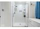 Modern bathroom featuring a glass enclosed shower with a rainfall showerhead and built in shelving at 7250 Royal Oakland Dr, Indianapolis, IN 46236