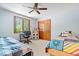 Bright bedroom featuring a ceiling fan, a large window, and a cozy study nook at 7250 Royal Oakland Dr, Indianapolis, IN 46236