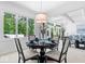 Bright dining room with a pendant light fixture, large windows, and elegant decor at 7250 Royal Oakland Dr, Indianapolis, IN 46236