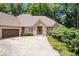 Charming brick ranch with manicured lawn, mature trees, and attached two-car garage at 7250 Royal Oakland Dr, Indianapolis, IN 46236