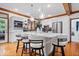 Bright kitchen features large island with seating, stainless steel appliances, and hardwood floors at 7250 Royal Oakland Dr, Indianapolis, IN 46236