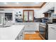 Bright kitchen featuring white cabinets, modern appliances, mosaic backsplash and wood trim at 7250 Royal Oakland Dr, Indianapolis, IN 46236