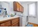 Well equipped laundry room with modern washer and dryer, ample storage, and a utility sink at 7250 Royal Oakland Dr, Indianapolis, IN 46236