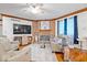 Cozy living room boasts a brick fireplace, ceiling fan, hardwood flooring and wainscotting at 7250 Royal Oakland Dr, Indianapolis, IN 46236