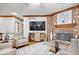 Cozy living room boasts a brick fireplace, ceiling fan, hardwood flooring and wainscotting at 7250 Royal Oakland Dr, Indianapolis, IN 46236