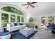 Bright living room with many windows and a door to the deck that lets in ample natural light at 7250 Royal Oakland Dr, Indianapolis, IN 46236