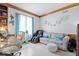 Well-lit home office with a comfortable seating area, desk, and decorative wall accents at 7250 Royal Oakland Dr, Indianapolis, IN 46236