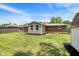 Spacious backyard with lush green grass, mulch landscaping, and a house extension; perfect for outdoor activities at 734 Summitcrest Dr, Indianapolis, IN 46241