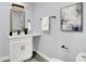 Modern bathroom featuring a white vanity, wood-framed mirror, and sleek black fixtures at 734 Summitcrest Dr, Indianapolis, IN 46241
