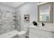 Bathroom featuring a marble walk-in shower, modern vanity, and a decorative mirror at 734 Summitcrest Dr, Indianapolis, IN 46241