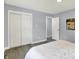 This bedroom includes sleek grey flooring and a spacious closet with sliding doors at 734 Summitcrest Dr, Indianapolis, IN 46241