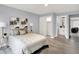 Bedroom with a bed, side tables, lamps, closet, and a view of the ensuite bathroom at 734 Summitcrest Dr, Indianapolis, IN 46241