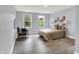 Bedroom with a bed, accent chair, two windows, and natural light from the outside at 734 Summitcrest Dr, Indianapolis, IN 46241