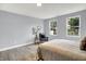 Bedroom showcasing natural light, a sitting area, and a calm, neutral color palette at 734 Summitcrest Dr, Indianapolis, IN 46241