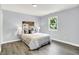 This primary bedroom features beautiful grey flooring, a window, and cool gray walls at 734 Summitcrest Dr, Indianapolis, IN 46241