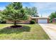 Charming brick ranch home with a lush front yard and a welcoming two-car garage at 734 Summitcrest Dr, Indianapolis, IN 46241