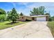 A beautiful brick home featuring a well-maintained front yard and a two-car garage at 734 Summitcrest Dr, Indianapolis, IN 46241