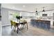 Open kitchen with white cabinets, a dining table, and a large island providing ample counter space at 734 Summitcrest Dr, Indianapolis, IN 46241