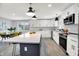 Bright kitchen featuring white cabinets, stainless steel appliances, and an island with a marble countertop at 734 Summitcrest Dr, Indianapolis, IN 46241