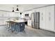 Modern kitchen with white cabinetry, stainless steel appliances, and a large island with bar stool seating at 734 Summitcrest Dr, Indianapolis, IN 46241