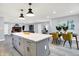 A modern kitchen seamlessly connecting to the living room and dining area with stylish finishes at 734 Summitcrest Dr, Indianapolis, IN 46241
