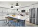 A modern kitchen featuring white cabinets, stainless steel appliances, and a large center island with seating at 734 Summitcrest Dr, Indianapolis, IN 46241