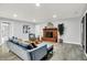 A well-lit living room with modern finishes, a brick fireplace and stylish décor at 734 Summitcrest Dr, Indianapolis, IN 46241