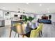 Open-concept floor plan with a modern kitchen, dining area, and living room featuring a brick fireplace at 734 Summitcrest Dr, Indianapolis, IN 46241