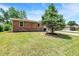 A large yard provides a great space, surrounded by green grass and mature trees at 734 Summitcrest Dr, Indianapolis, IN 46241