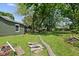 Backyard featuring green grass, mature trees and the home's exterior at 761 N Holmes Ave, Indianapolis, IN 46222