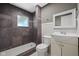 Bathroom with tiled shower, toilet and sink with vanity and decorative mirror at 761 N Holmes Ave, Indianapolis, IN 46222