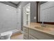 Well-lit bathroom equipped with a stand-up shower, modern sink, and stylish vanity at 761 N Holmes Ave, Indianapolis, IN 46222