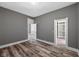 Hardwood bedroom showcasing an open closet and access to an adjacent room at 761 N Holmes Ave, Indianapolis, IN 46222