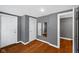 Bedroom with gray walls, wood floor, and two white doors plus a wall mirror at 761 N Holmes Ave, Indianapolis, IN 46222