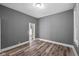 Cozy bedroom featuring hardwood floors, light gray walls, and an open closet at 761 N Holmes Ave, Indianapolis, IN 46222